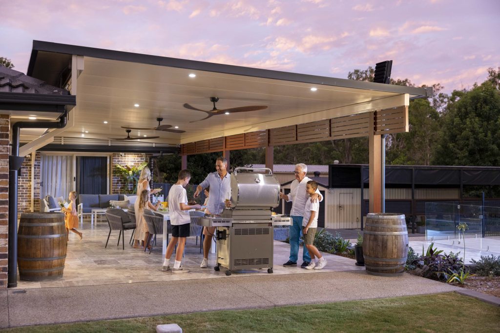 Family enjoying a BBQ on an Apollo Patio